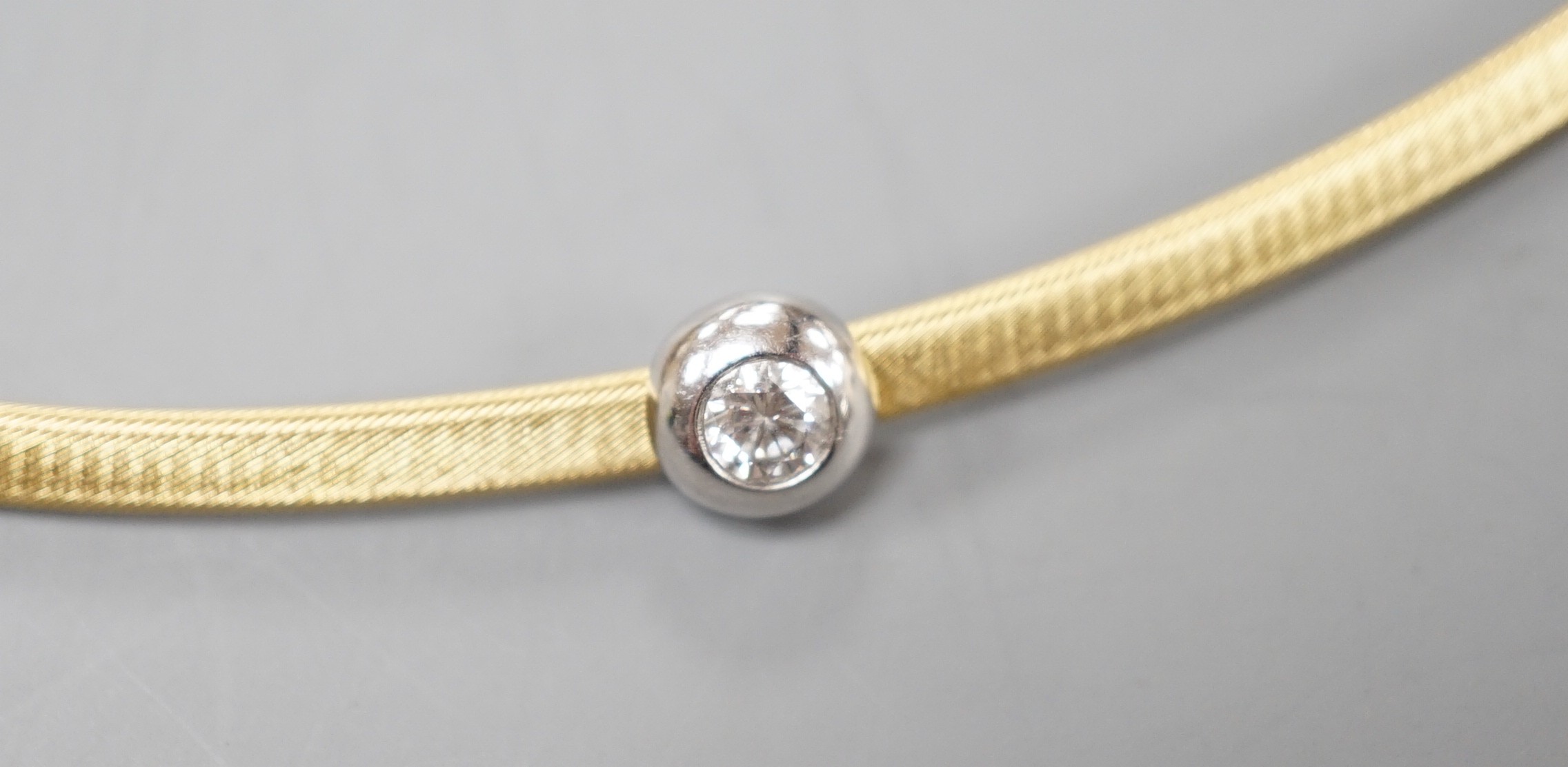 A modern 750 yellow metal and solitaire diamond set necklet, approx. 34-36cm, gross weight 8.2 grams.